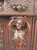 109 - 1911 Sideboard by Oriel Cabinet Co. that features massively carved mascarons, Norman soldiers, atlantes and caryatid figures as well as griffins in full relief (part of the "Norman Suite"), 99in. tall, 82in. wide, 28in. deep (caryatid figure, 2)