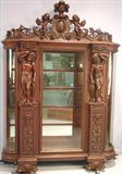 110 - 1911 China Cabinet by Oriel Cabinet Co. that features massively carved mascarons, Norman soldiers, atlantes and caryatid figures as well as griffins in full relief (part of the "Norman Suite"), 94in. tall, 66.5in. wide, 19in. deep