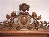 110 - 1911 China Cabinet by Oriel Cabinet Co. that features massively carved mascarons, Norman soldiers, atlantes and caryatid figures as well as griffins in full relief (part of the "Norman Suite"), 94in. tall, 66.5in. wide, 19in. deep (crown)