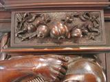 110 - 1911 China Cabinet by Oriel Cabinet Co. that features massively carved mascarons, Norman soldiers, atlantes and caryatid figures as well as griffins in full relief (part of the "Norman Suite"), 94in. tall, 66.5in. wide, 19in. deep (close-up, 2)