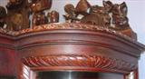 110 - 1911 China Cabinet by Oriel Cabinet Co. that features massively carved mascarons, Norman soldiers, atlantes and caryatid figures as well as griffins in full relief (part of the "Norman Suite"), 94in. tall, 66.5in. wide, 19in. deep (crown, 2)