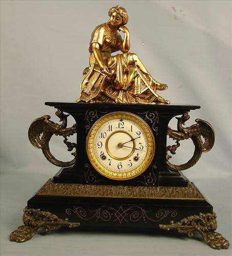 47 - Ansonia Belgium Clock with gargoyles and topper, 20in T, 18in. W, 7in. D.