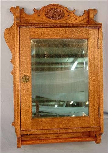 160 - Oak Medicine Cabinet, 31in. T, 22in. W,  shaped side wings, applied carving on top, beveled mirror, towel bar, ca. 1900