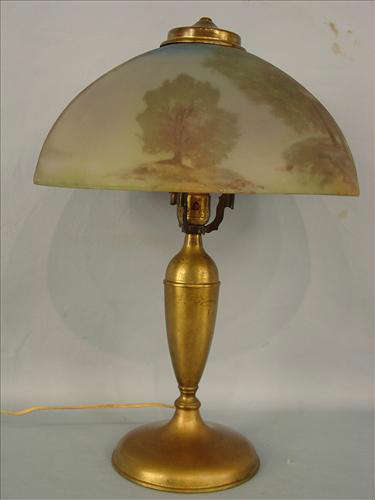 254 - Metal Base Lamp with reverse painted glass shade, 21in. T, 14in. Dia. Landscape and gristmill scene, mostly green glass, ca. 1925.