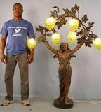 277 - Metal Art Nouveau Landing Light of lady with grapes, 64in. T, 47in. W, has black marble base, extremely rare for size, ca. 1920.