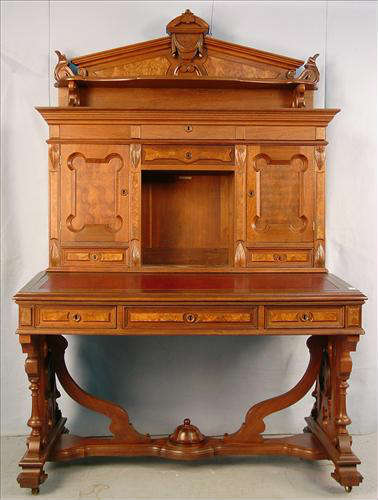293 - Victorian Desk with library style base and stretcher, sloped writing surface with pigeon holes and Lincoln drape carved crest, ca. 1870, 81in. T, 52in. W, 32in. D.
