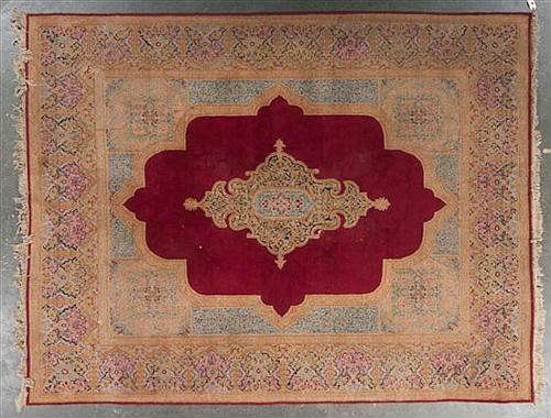 328 - Hand Made Rug with center medallion, Persian Kerman, 9ft. 3in. X 11ft. 9in., dark red and gold.