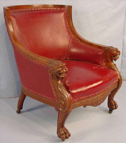 385 - Mahogany Arm Parlor Chair with carved loins head on arms, claw feet, red upholstery, att. to Horner, ca. 1900.