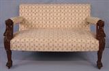 395 - Mahogany Love Seat with wing griffins on each arm, claw feet and floral upholstery, 29in. T, 97in. W, 24in. D.