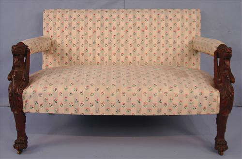 395 - Mahogany Love Seat with wing griffins on each arm, claw feet and floral upholstery, 29in. T, 97in. W, 24in. D.