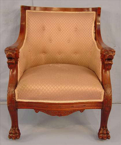 393 - Solid Mahogany arm chair with carved lions head on  arms and claw feet, has lavender upholstery, 36in. T, 28in. W, 23in. D.