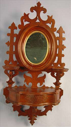 404 - Victorian Walnut Hanging Comb Case with oval mirror, candle stand, serpentine front, ornate comb box with lift lid, ca. 1880, 29in. T, 14in. W.
