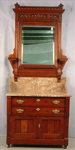 402 - Victorian Walnut Hotel Style Mirrored Washstand, 2 drawers, 2 door base, leaf carving, gallery spindle top with brown marble, 81in. T, 34in. W, 18in. D.