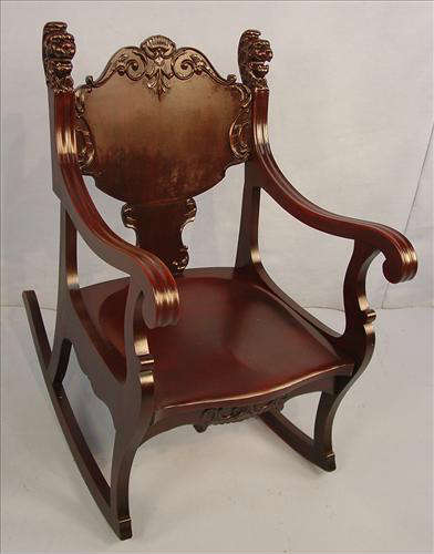 423 - Solid Mahogany Curved Rocker with lions head on both sides of back and other carving, ca. 1880, 34in. T, 23in. W, 20in. D.