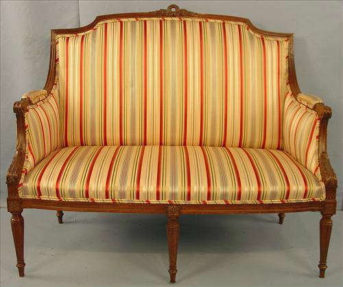 450 - French Walnut High Back Love Seat with 6 legs, carving and yellow stripe upholstery, ca. 1890