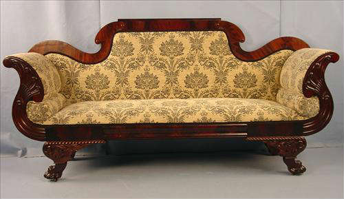 455 - Flame Mahogany Empire Sofa with curved arms, heavily carved legs and claw feet with gold floral upholstery, ca. 1875, 41in. T, 44in. L, 22in. D.