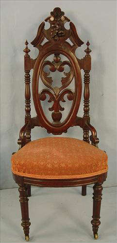 460 - Walnut Victorian Pierced Carved Music Chair with orange upholstery, nuts carved in crown, ca. 1870, 41in. T, 18in. W, 16in. D.