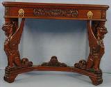 491 - Mahogany Console Table with carved full body winged griffins and brass lions head pulls, 31in. T, 40in. W, 17in. D. with white marble top.