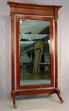 109 - Mahogany empire cheval mirror with carved crown, brass caps on post and brass feet, 82in. T, 41in. W, ca. 1880.