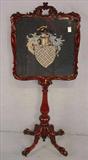 202 - Rosewood rococo fire screen with needle point shield crest, 50in. T, 22in. W, ca. 1860.