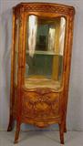 308 - Gold curved glass curio cabinet with heavily carved with glass shelves and mirrored back, 55in. T, 27in. W, 15in. D, ca. 1930.