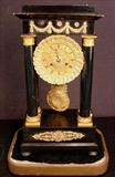 603 - Early empire clock under glass dome, 27in. T, 14in. W, 8in. D.
