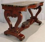 503 - Mahogany Empire center table with black and gold marble, scroll feet, 42in. L, 22in. D, 28in. T, marble on top of stretcher, ca. 1850.