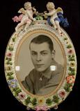 452 - Dresden porcelain oval picture frame with cupids, wood back, ca. 1900, 15in. T, 10in. W