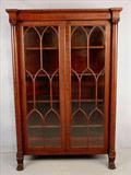 455 - Mahogany Empire china cabinet with column front and claw feet, has individual glass panel in doors, 72in. T, 48in. W, 17in. D., ca. 1880.
