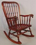 474 - Heavy mahogany spindle back rocker with lions head in arm, 39in. T, 25in. W, 19in. D.