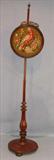 317 - Rosewood Victorian needlepoint fire screen, 57in. T, screen is 13in. Dia. Ca. 1860.