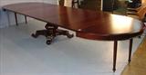 487 - 54in. Mahogany empire table with seven 19in. Leaves, has pumpkin base, 29in. T, 54in. Dia.