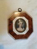 132 - Small ivory and walnut frame with painting on ivory, girl with flower in hair.