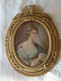 137 - Small oval gold Victorian frame with painting on ivory of girl in blue formal dress.