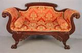 51 - Mahogany Empire love seat with deep curved arms, ball and claw feet, 35in. T, 57in. W, 22in. D, ca. 1880.