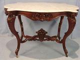 202 - Walnut rococo turtle top Parlor table with heads on all four corners, pierced carvings, 44in. W, 30in. D, ca. 1850.