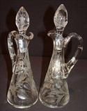 212 - Matching cut glass oil and vinegar cruets, intaglio pattern, 11in. T.
