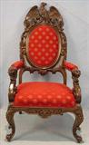 256 - Oversized walnut arm chair with lions head and large eagle, 52in. T, 27in. W, 23in. D.