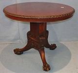 259 - Round mahogany center table with gadrooned top and ball and claw feet, 30in. T, 36in. Dia.