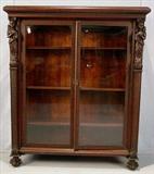 265 - Mahogany 2 door bookcase with lady figures and claw feet, 61in. T, 53in. W, 17in. D.