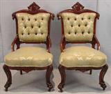 323 - Pair of Victorian hip rest parlor chairs with green and gold upholstery, ball and claw feet.