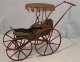 324 - Old Victorian doll buggy with wood wheels and fringe on top, 25in. tall, 11in. wide, 28in deep, ca.1870.