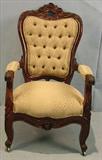 325 - Rosewood heavly carved Victorian arm chair with roses carved in crown and gold upholstery, 43in. tall, 26in. wide, 24in. deep, ca. 1860.