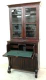 1353 - Mahogany empire butlers secretary desk with glass doors at top, scroll feet, 7ft 10in. T, ca. 1840.