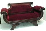 1354 - Mahogany empire love seat with acanthus carved arms, heavily carved legs and feet, maroon upholstery, ca. 1880.