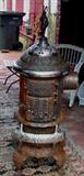21 - Cast iron wood stove made by Round Oak Model D-14, Indian on top, 52in. T.