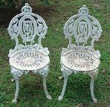 232 - Pair of white case iron garden chairs