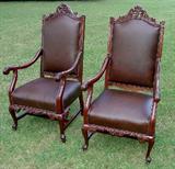 252 - Pair of Walnut throne chairs with brown leather upholstery, 51in. T, 26in. W. 23in. D.