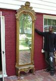 257 - Free  standing gold victorian pier mirror with heavily decorated crown, 103in. T, 30in. W.