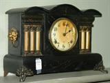 331 - Mantle clock by Gilbert with brass feet and lions head, 12in. T, 17in. W, 7in. D.